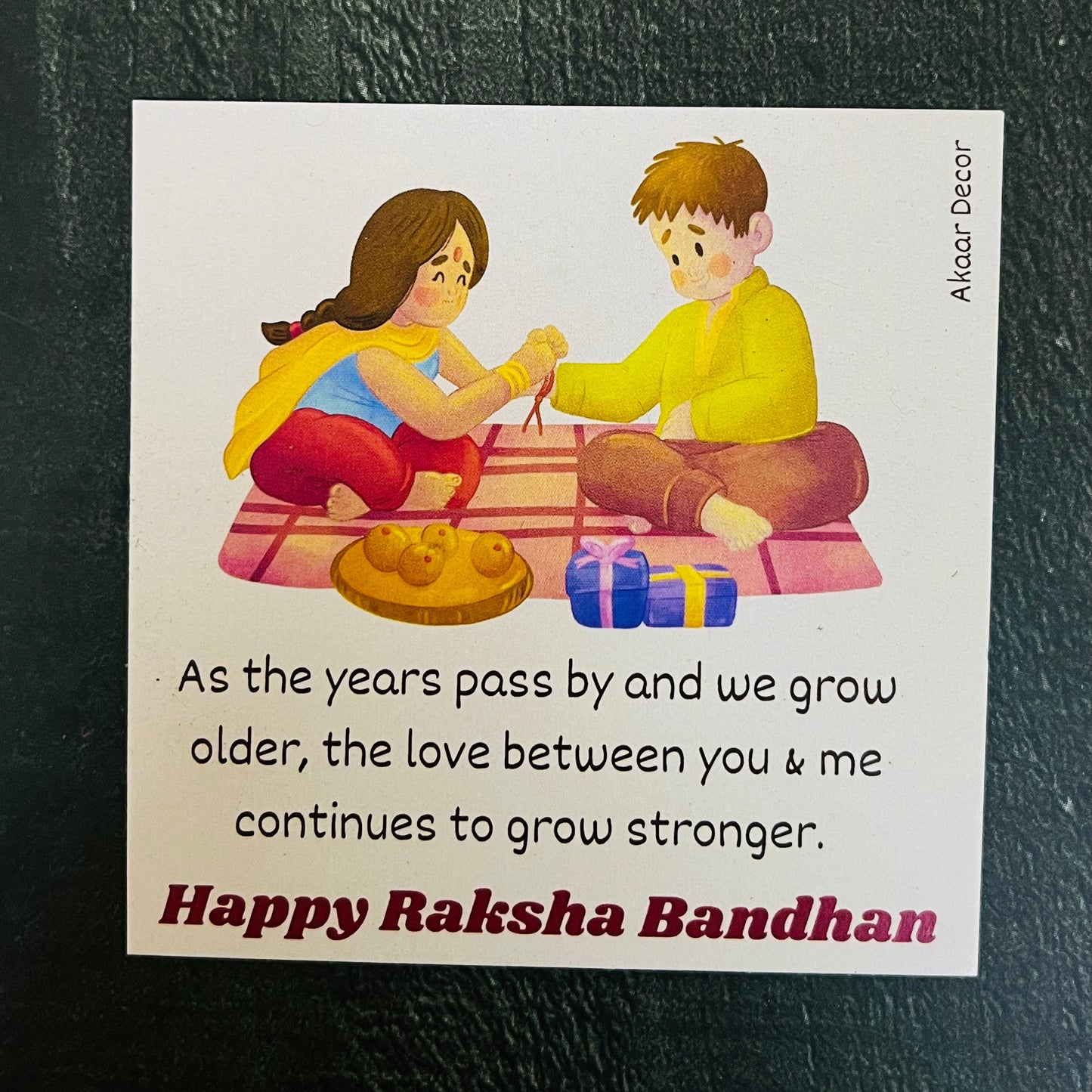 Trendy Rakhi Set with  Plate, Roli Moli, 3 Rakhis, Greeting Card, and 2 Fridge Magnets